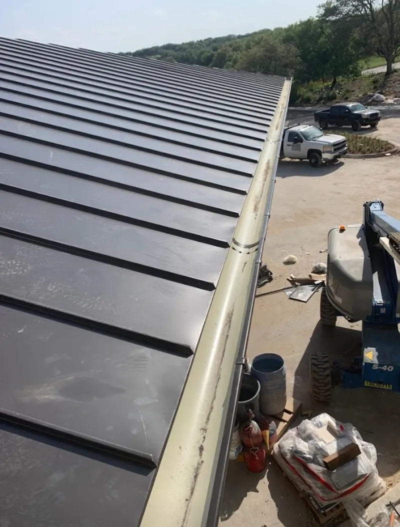 Standing seam panel and gutter detail on a metal roofing jobsite in Fairwood
